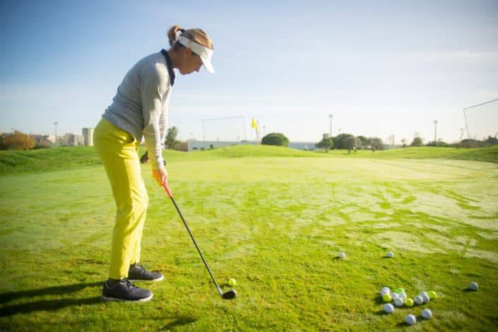 Woman on Green Grass Playing Golf