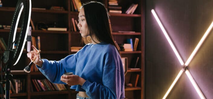 Woman Filming Herself Using a Phone and Ringlight