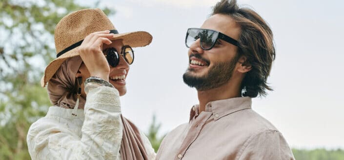 Couple Wearing Sunglasses Laughing