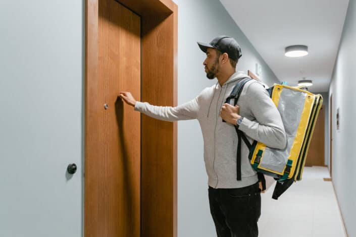 Deliveryman knocking on a door