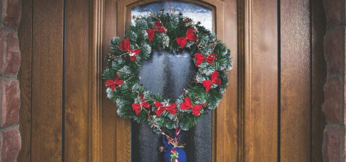 Green and red christmas wreath on door