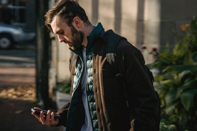 Man Checking His Phone - How to Comfort Someone Over Text 