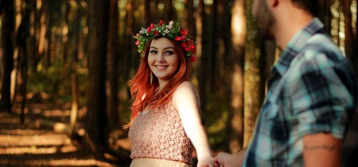 Couple Holding Hands While Standing Near Tree