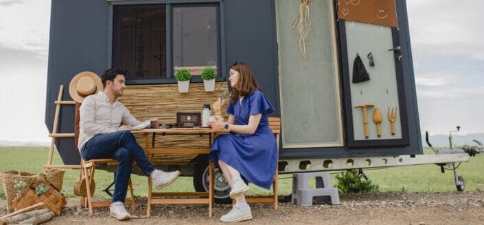 Man and Woman Sitting at a Brown Wooden Table