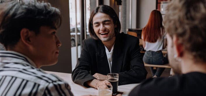 Man in black blazer having a drink