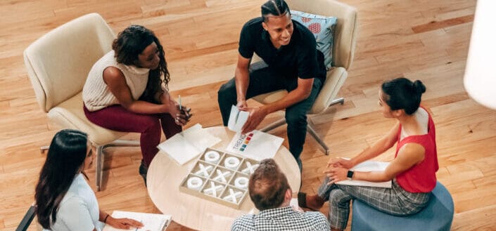 People at Office Lobby Playing a Game