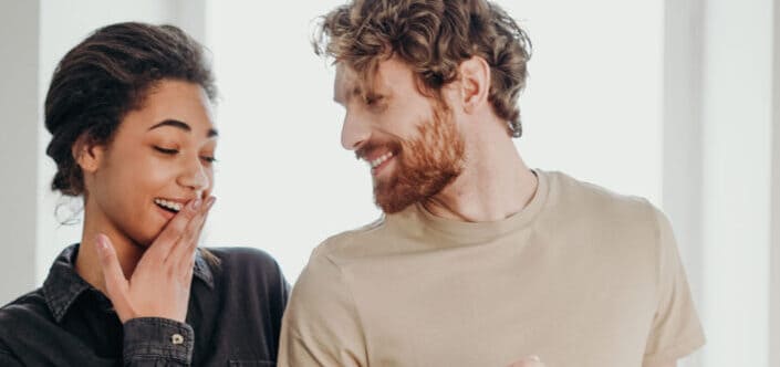 Woman giggling beside man