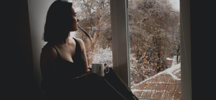 Woman Sitting by the Window