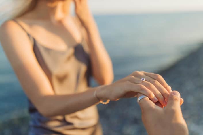 Woman in White Tank Top Showing Off Her Ring