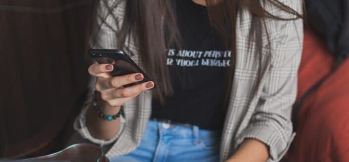 Young Woman Browsing Through Her Phone