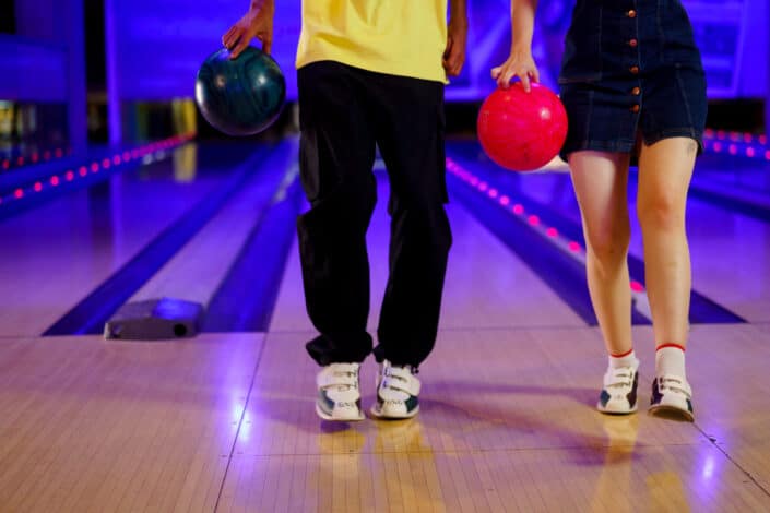 Couple holding bowling balls
