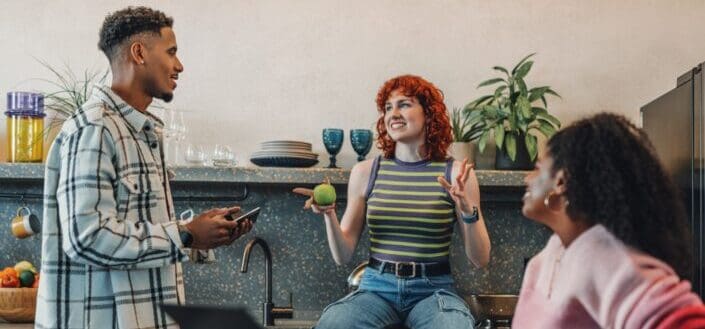 group of people talking in a kitchen