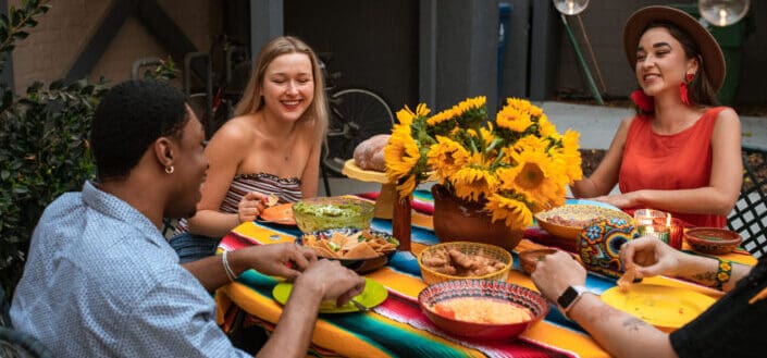 A people eating while talking together