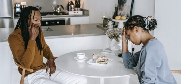 African american couple arguing at kitchen table