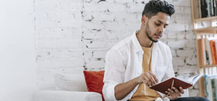Attentive Man Reading Notes in Diary