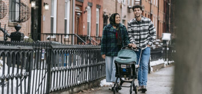 Cheerful couple with baby in stroller