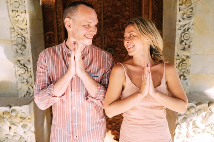 Couple in praying pose smiling