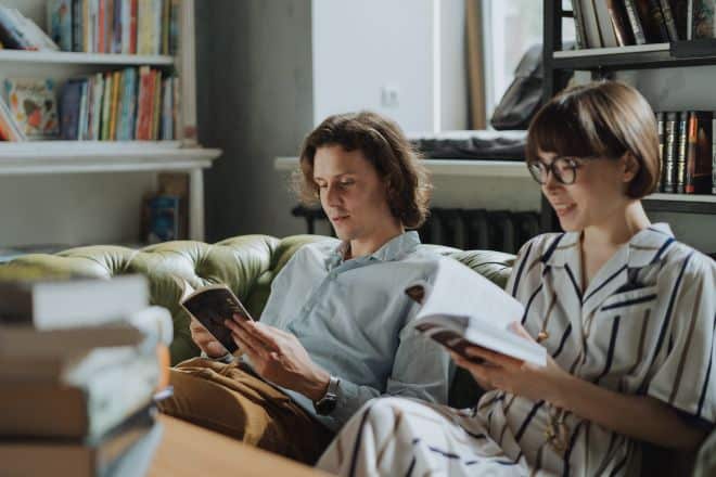 couple sitting on the couch reading books - Hard Riddles