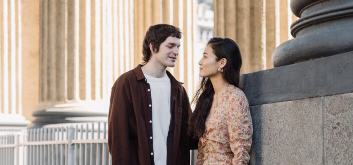 Man and woman standing in colonnade