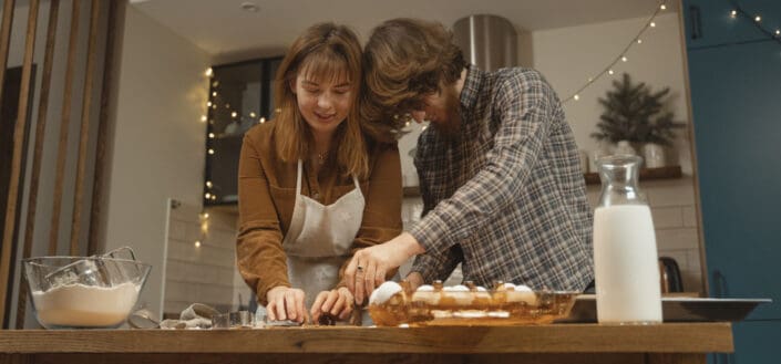 Man and woman preparing meal in kitchen