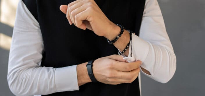 man in black jacket fixing sleeves