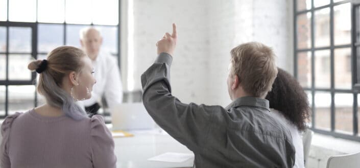 Man Raising His Hand in a Meeting