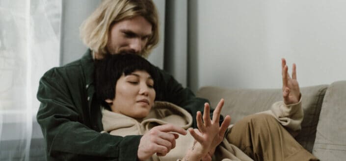 Woman leaning on a man on sofa