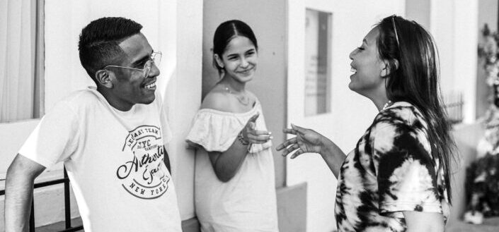 group of people smiling while talking