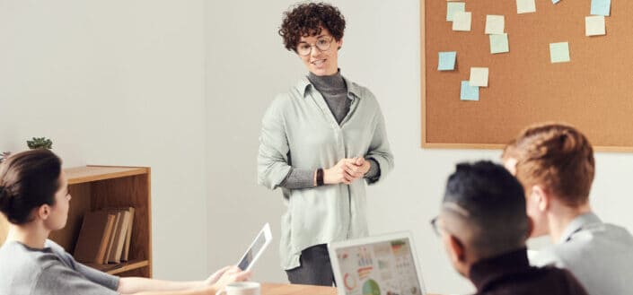 Woman Doing a Presentation For Her Officemates