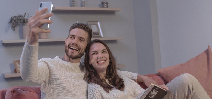 Couple on a Video Call With Someone on Their Phone