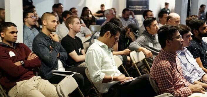 An audience listening to a speaker