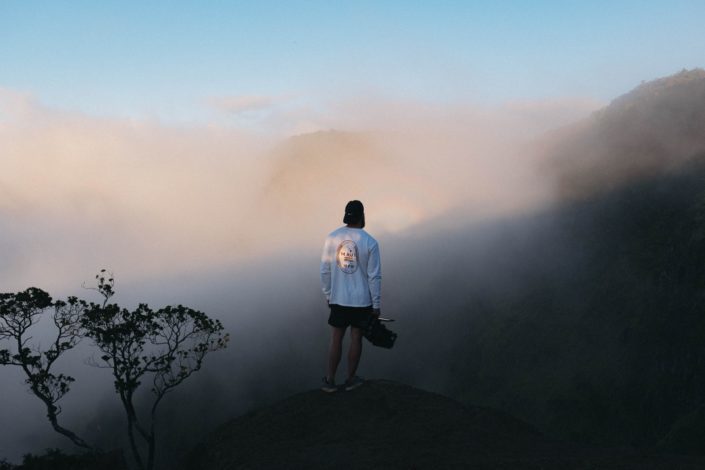Man standing on a foggy mountain top.