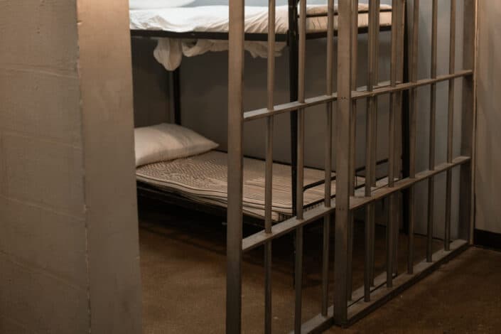 bunk bed in prison behind bars