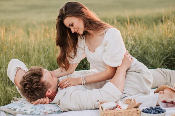 A couple having a picnic on the grass field