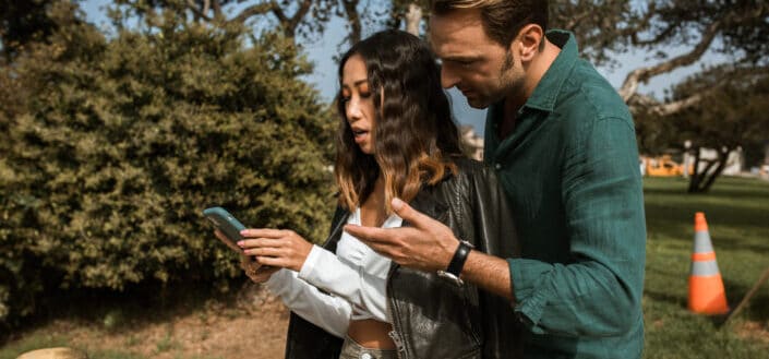 couple having an argument while using phone