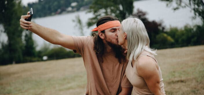 Couple Taking a Selfie While Kissing