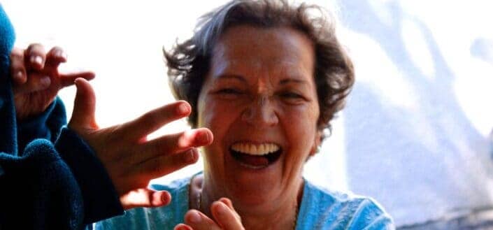 A grandchild clapping at his grandmother in her birthday.