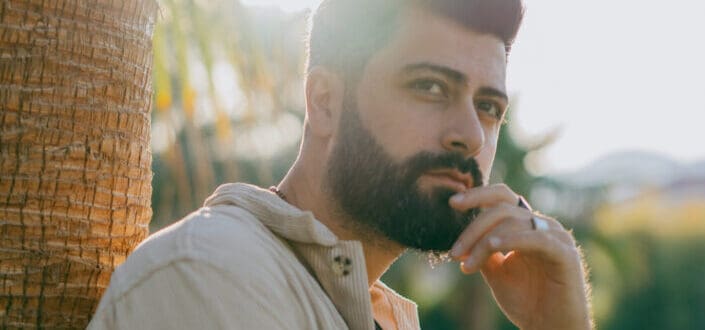 A bearded man looking away