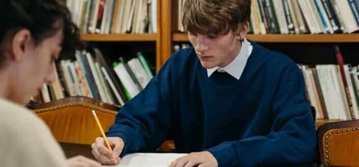 Man and Woman Studying in The Library