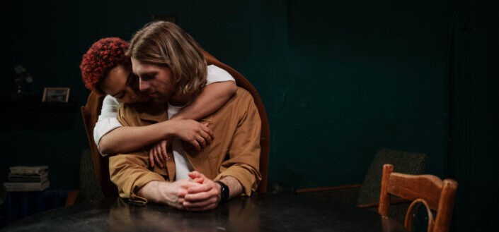 Red hair woman hugging her man