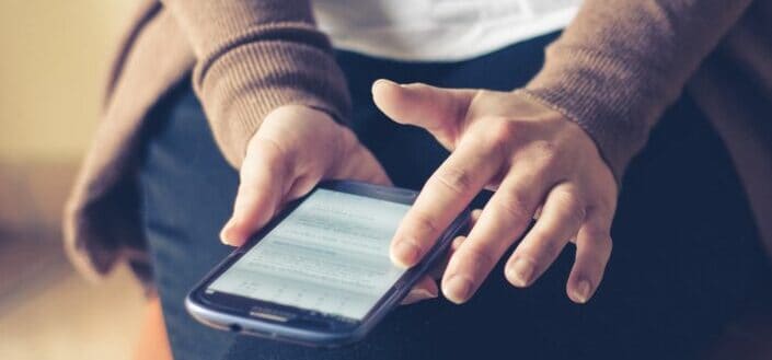 person holding an old android phone