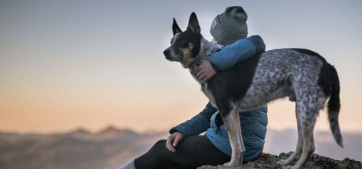 man sitting with his dog beside him