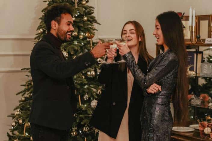three people having a toast during Christmas season 