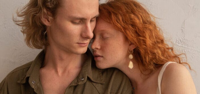 Calm couple embracing in light room