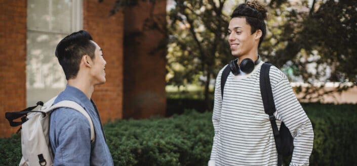 Cheerful Students Discussing University Studies in Campus