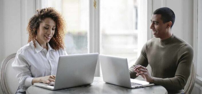 Young Couple Using Laptops At Home