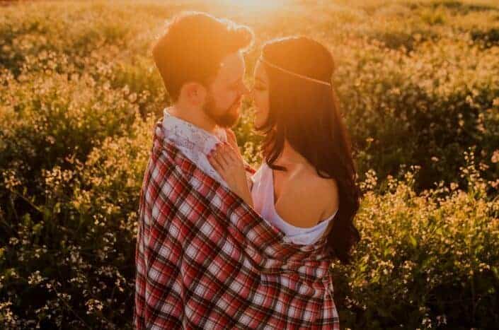 couple cuddling during sunset 