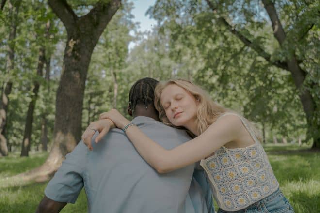 couple hugging in the park - clingy girlfriend 