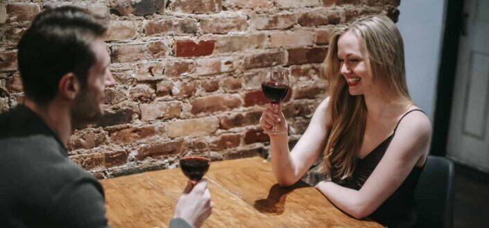 Couple enjoying date in restaurant with wineglasses