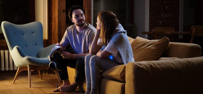 Couple talking intimately on couch